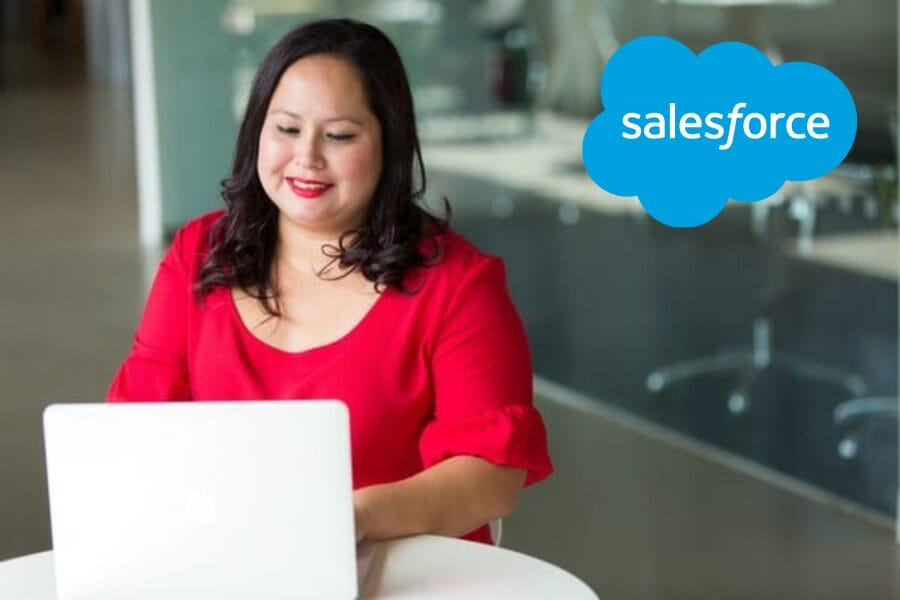 Blog post image—woman at laptop with Salesforce logo