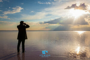 man with binoculars looking out over the horizon